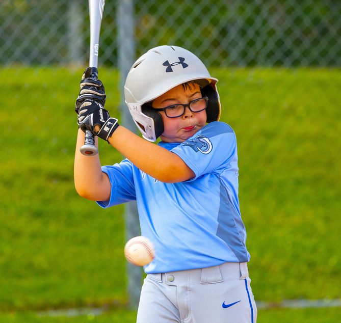 Young batter watching the ball come in